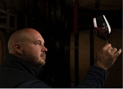 MCV Winemaker examines glass of wine 