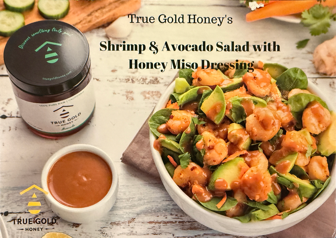 Shrimp and avocado salad with honey miso dressing, with honey jar and dressing cup nearby