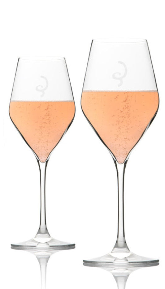 Two wine glasses filled with rosé on a white background