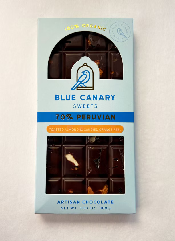 Chocolate bar in light blue cardboard wrappe on white background