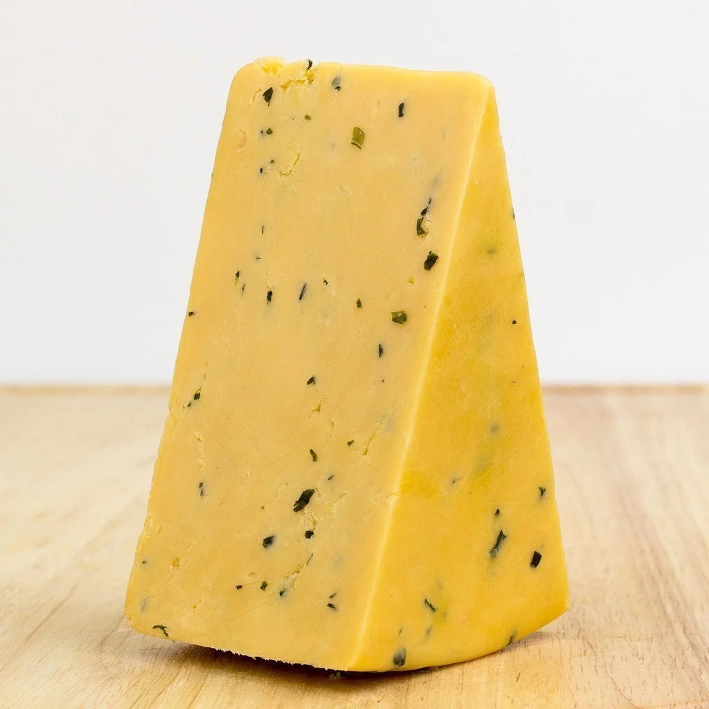 Wedge of Cotswold cheese - an orange cheese speckled with onion and  chive