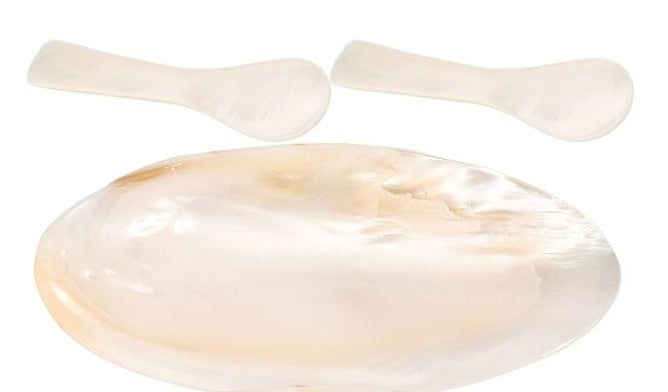 A set of mother-of-pearl Caviar service, including a two serving spoons and one small plate for two, shown on a plain white background.
