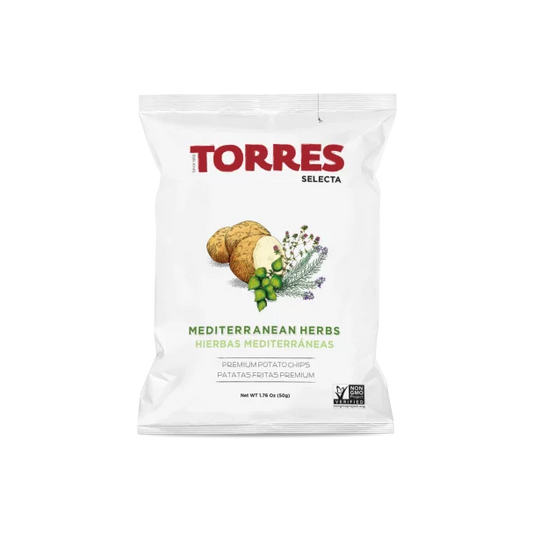 A white bag of Torres Selecta Mediterranean Herbs potato chips on a plain white background. The packaging features the red 'TORRES' brand name, green and brown illustrations of potatoes and herbs, and text indicating 'MEDITERRANEAN HERBS HIERBAS MEDITERRANAE'.